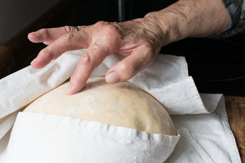 Human hand checking rising of yeast dought. Black background. Dought stock images, royalty-free photos and pictures