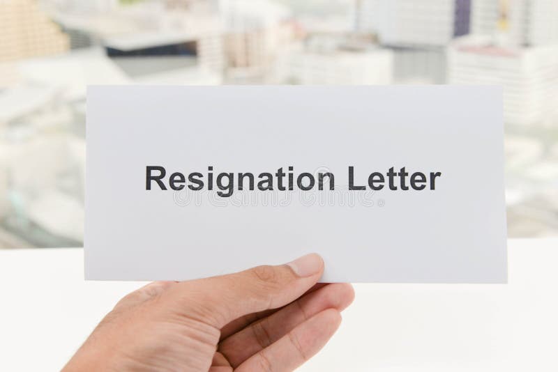 Human hand is holding the letter of Resignation royalty free stock photos
