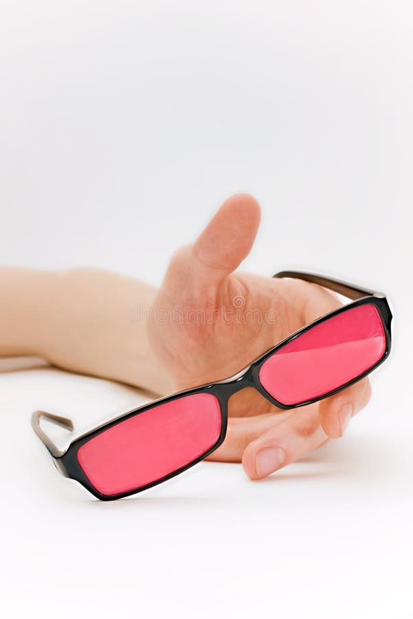 Human hand with pink glasses