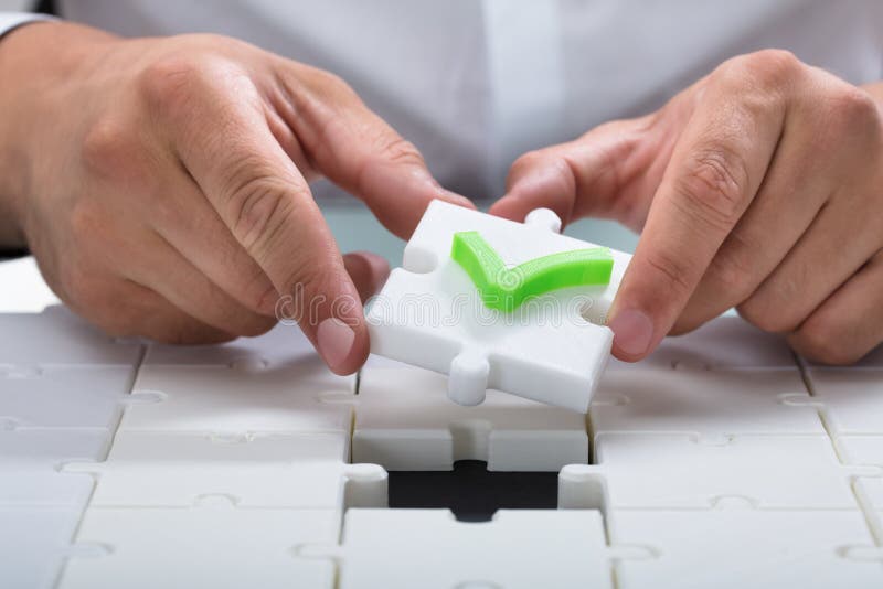 Human hand solving jigsaw puzzle stock photography Human hand solving jigsaw puzzle stock photography