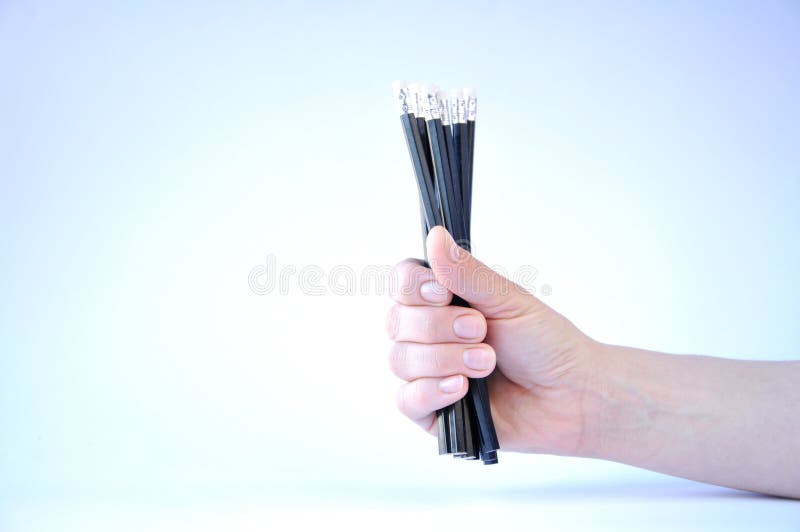 many black pencils in hand on white background stock image many black pencils in hand on white background stock image