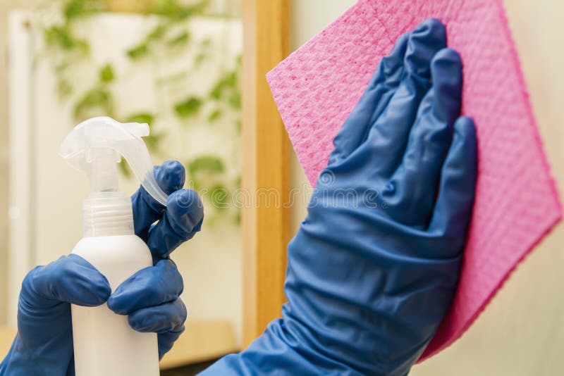 A Human Hands in a Protective Gloves Disinfect Surface Using