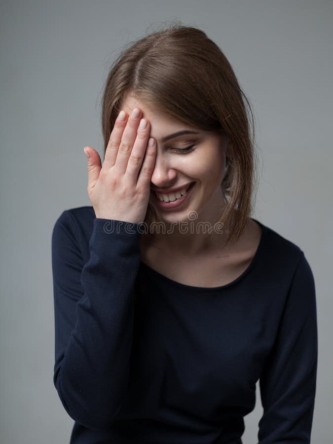 Human positive emotions and feelings. Headshot of cute attractive young European female covering open mouth with hand and closing royalty free stock photo Human positive emotions and feelings. Headshot of cute attractive young European female covering open mouth with hand and closing royalty free stock photo