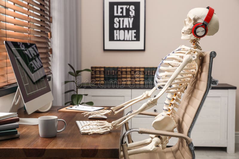 Human skeleton with headphones using computer. 
