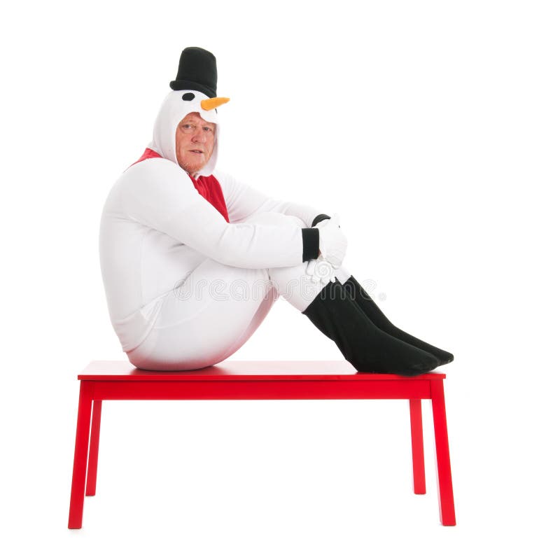 Human snowman sitting on bench stock photography