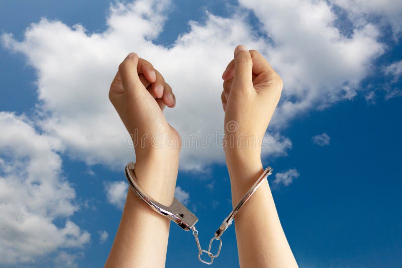 Human trafficking ,slave labor and labor oppression problems concept. two hands was incarcerated by handcuff with blue sky royalty free stock image Human trafficking ,slave labor and labor oppression problems concept. two hands was incarcerated by handcuff with blue sky royalty free stock image