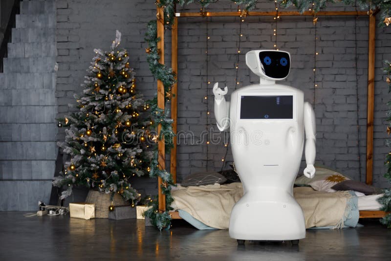 Humanoid autonomous robot on the background of Christmas decorations, Christmas tree, bokeh royalty free stock image Humanoid autonomous robot on the background of Christmas decorations, Christmas tree, bokeh royalty free stock image