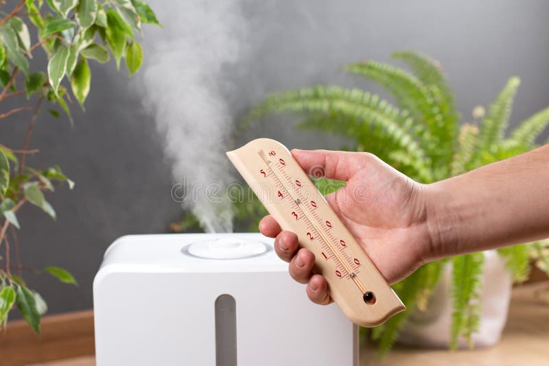 Humidifier and thermometer measuring the optimum temperature and humidity in a house apartment or office a photo for articles stock images
