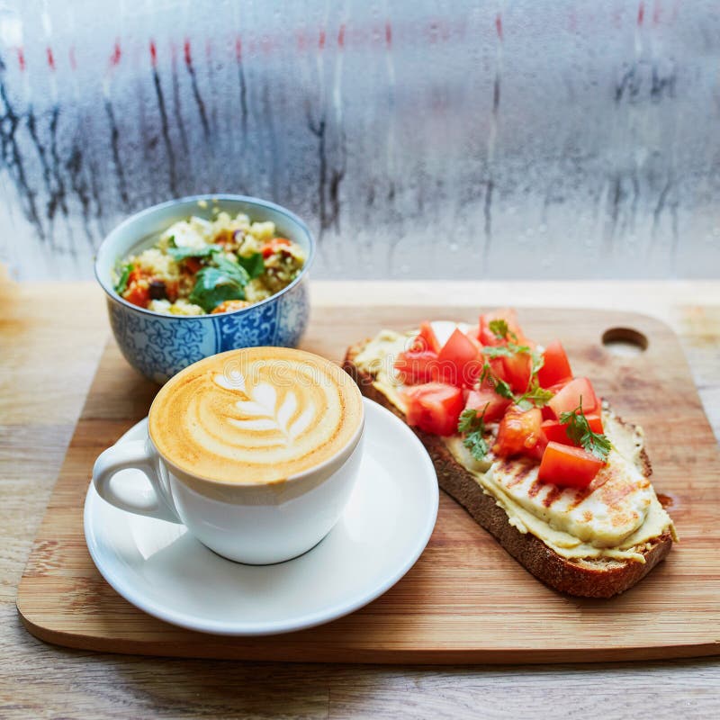 Hummus и сандвич томата, салат и свежий горячий кофе капучино