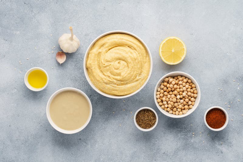 Hummus ingredienser Kikärt tahini, olivolja, sesam, örter arkivbild Hummus ingredienser Kikärt tahini, olivolja, sesam, örter arkivbild