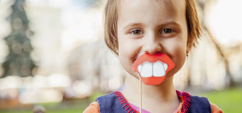 Humorous photo. Funny beautiful little child girl playing with f royalty free stock images