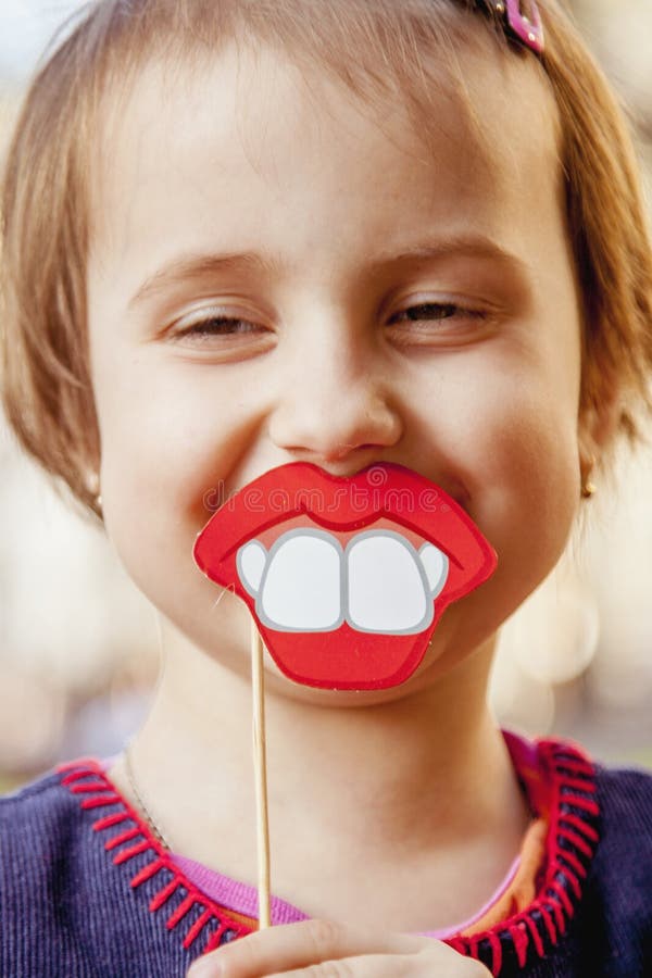 Humorous photo. Funny beautiful little child girl playing with f stock photos