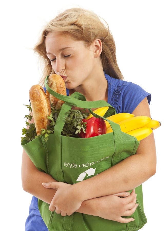 Humorous portrait of young woman kissing food