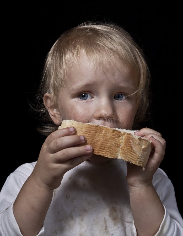 Hungry child eating bread royalty free stock photo Hungry child eating bread royalty free stock photo