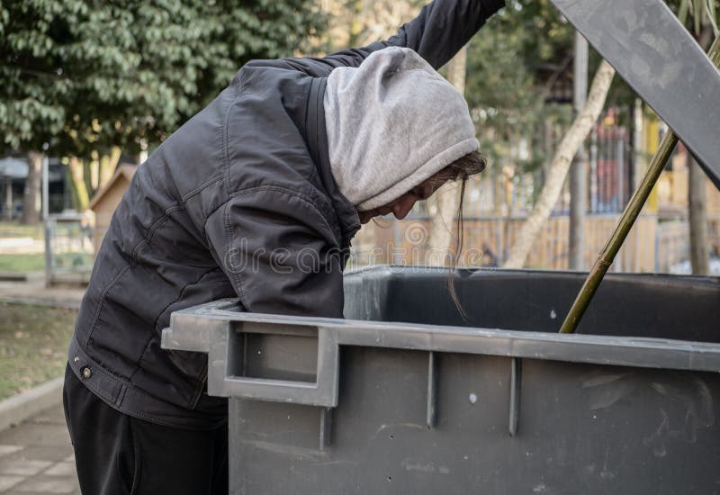 Hungry Homeless Man Rummaging in Trash Can Looking for Food Stock Photo ...