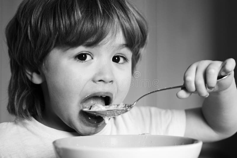 Hungry Little Boy Eating. Cheerful Baby Child Eats Food Itself with ...