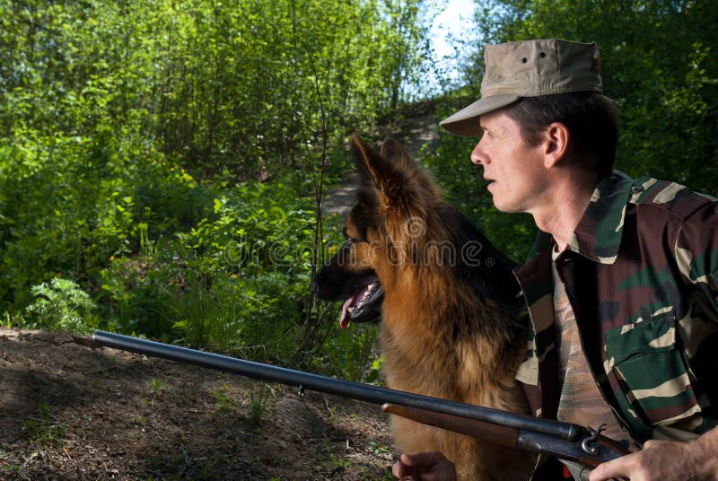 Hunter with dog in rifle. Ambush stock photos Hunter with dog in rifle. Ambush stock photos