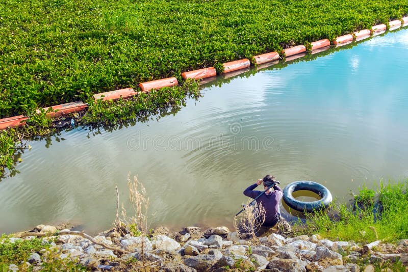 Hunter fisherman with a speargun on a life ring looks under the water in search of fish royalty free stock image Hunter fisherman with a speargun on a life ring looks under the water in search of fish royalty free stock image