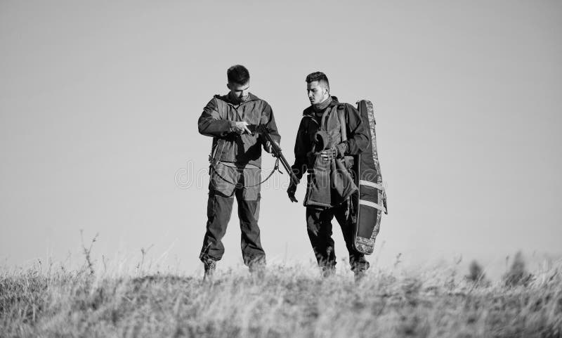 Hunter friend enjoy leisure in field. Hunting with friends hobby leisure. Safety rules concept. Be careful. Hunters stock photography Hunter friend enjoy leisure in field. Hunting with friends hobby leisure. Safety rules concept. Be careful. Hunters stock photography
