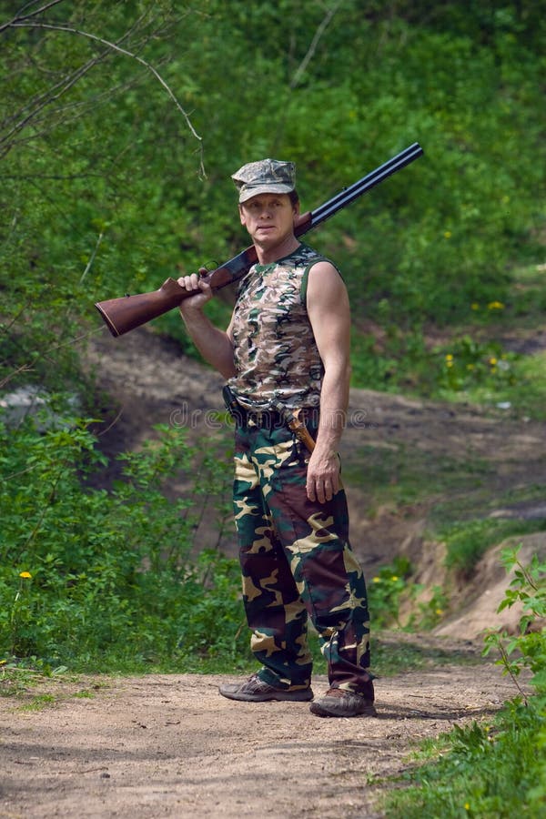 Hunter with gun in hand stock image