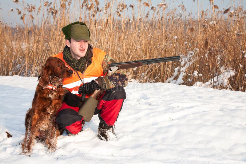 Hunter and his hunting dog in winter open season royalty free stock photography