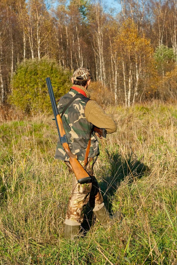 Hunter walking stock images