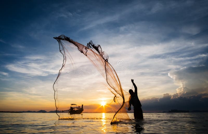 Hunting for Sunset. Silhouette of unidentified fisherman casting fishing net.