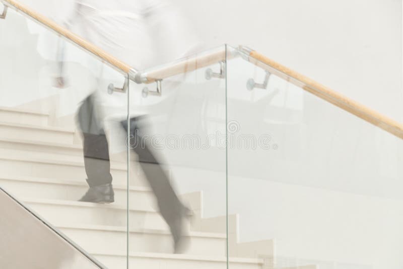 Hurry to save a life. Blur motion of doctor in white uniform hurrying and running upstairs