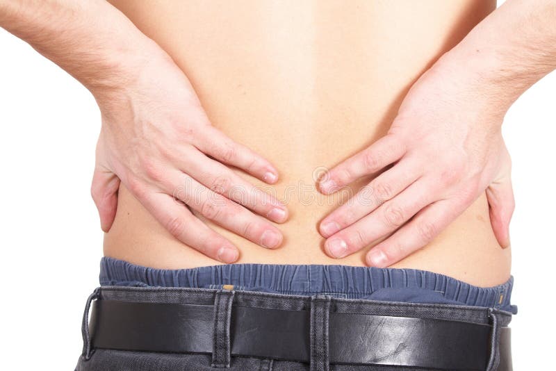 A young man holds back with both hands in pain. Isolated over white. A young man holds back with both hands in pain. Isolated over white.