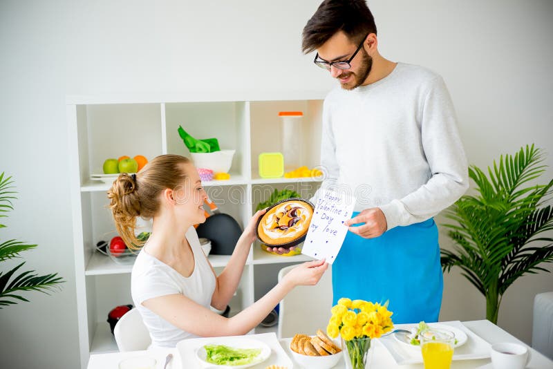 Husband cooking for wife stock image. Image of drink 93358119