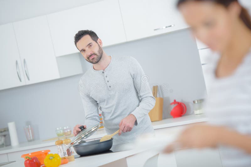 Husband cooking for wife stock image. Image of tasting 24730487