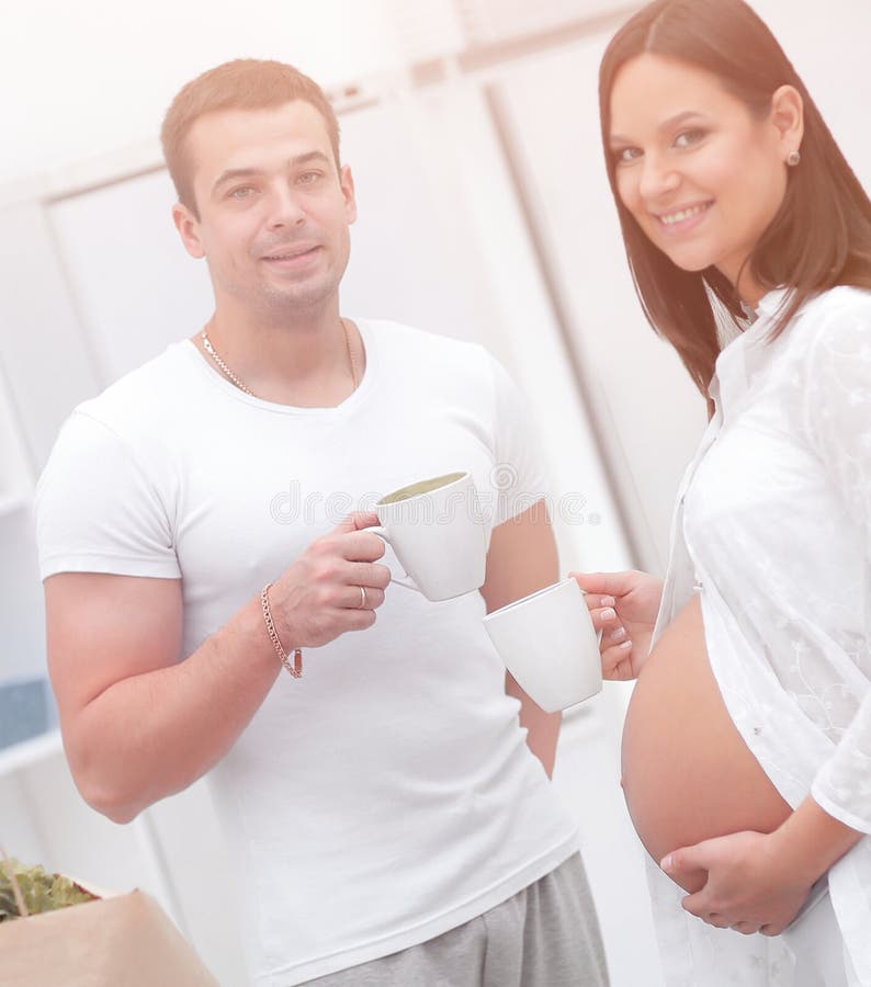 Husband And His Pregnant Wife Drinking Cocoa Standing In The Kitchen Stock Image Image Of 