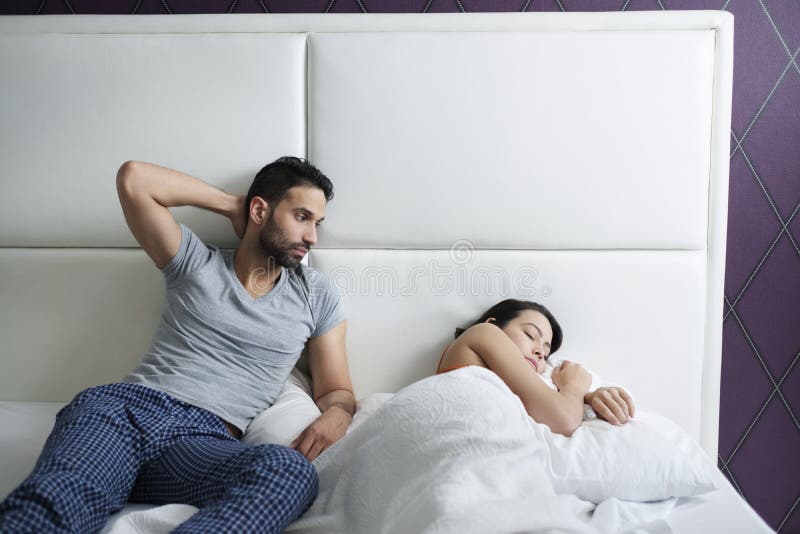 Man Trying Sexual Approach with Woman in Home Bed Stock Image pic
