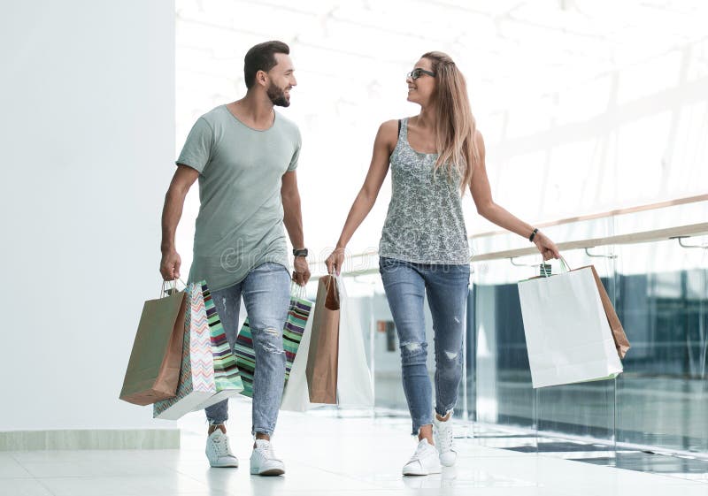 Husband and Wife with Shopping Bags Go Together Stock Photo - Image of adult, consumer: 131801250