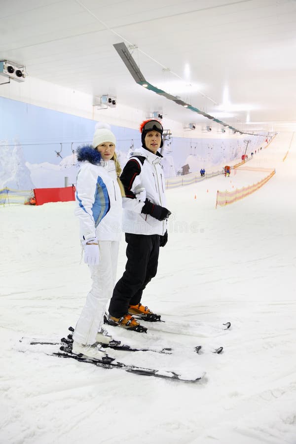 Husband and wife standing on skis