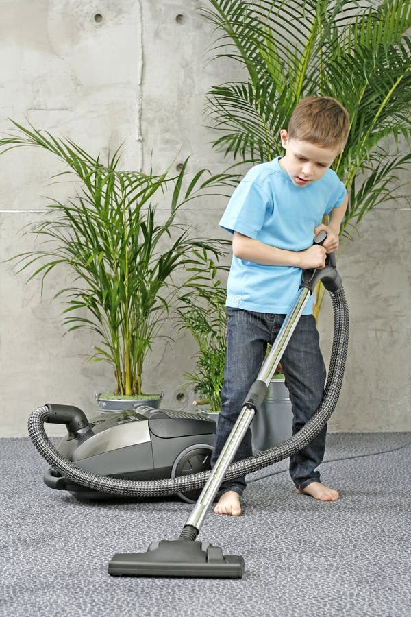 6-7 years old boy cleaning carper - housework. 6-7 years old boy cleaning carper - housework