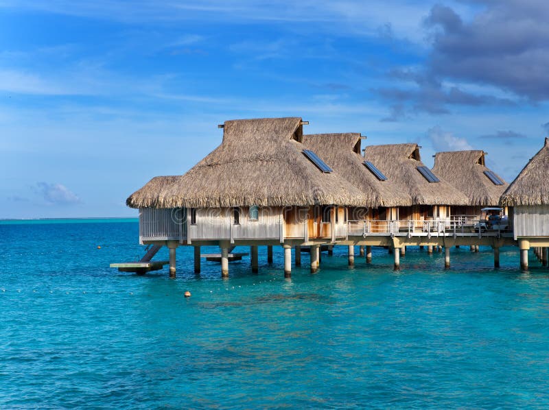 Huts with Straw Roofs Over the Blue Sea Stock Photo - Image of coral ...