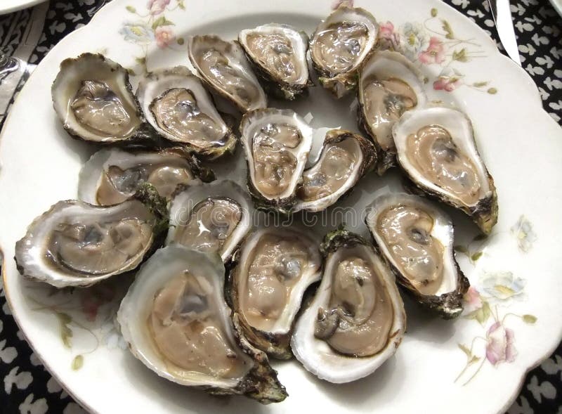 Big plate of raw oysters on the half-shell. Big plate of raw oysters on the half-shell