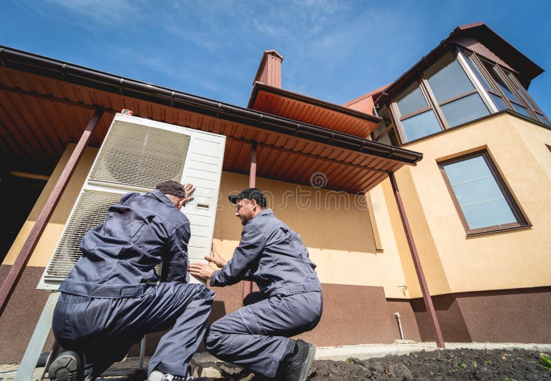 HVAC technicians servicing home heating and cooling system