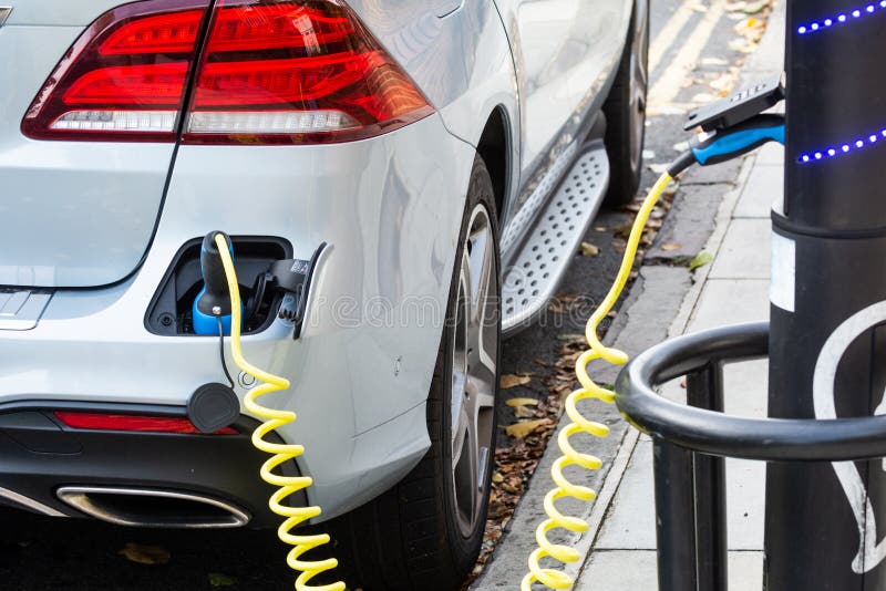 Electric Car Charging To Refuel at the Roadside Power Supply Stock