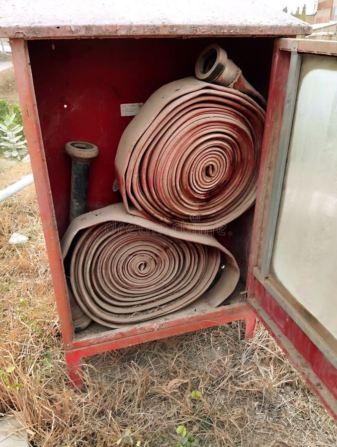 The hydrant hose reel and nozzle were in a dusty, rusty storage box stock images
