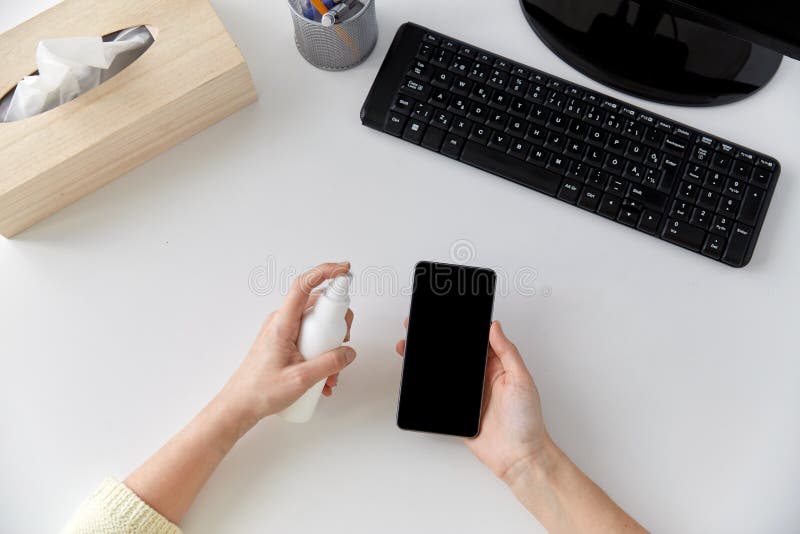 Close up of woman cleaning smartphone royalty free stock photo Close up of woman cleaning smartphone royalty free stock photo