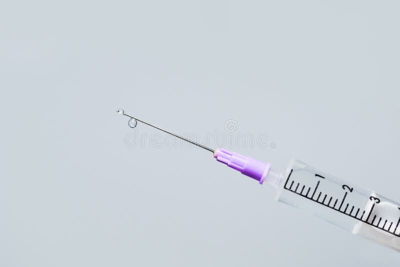 Hypodermic Needle Ejecting Clear Liquid Isolated Syringe Stock Photo