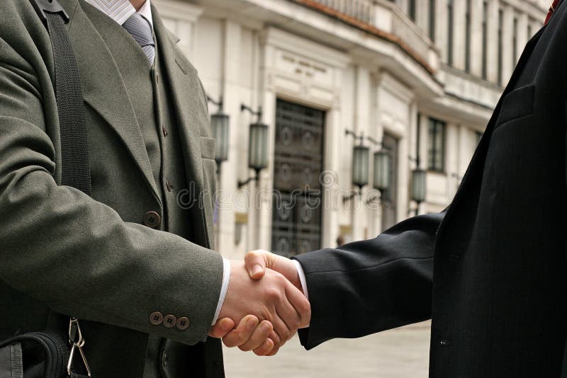 Handshake on a street, blurry buildings in the background. Handshake on a street, blurry buildings in the background