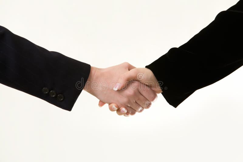 Two women's hands showing sleeve of business suit shaking hands. Two women's hands showing sleeve of business suit shaking hands