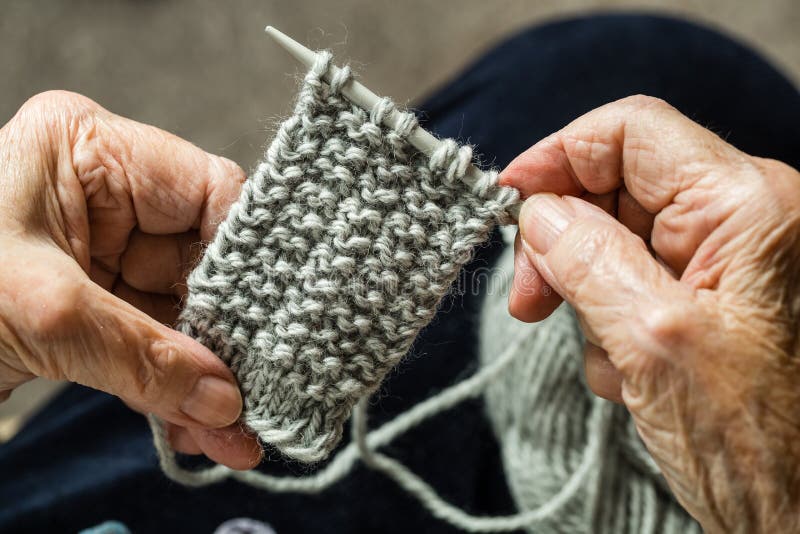 Close up of the hands of an elderly woman knitting. Close up of the hands of an elderly woman knitting.