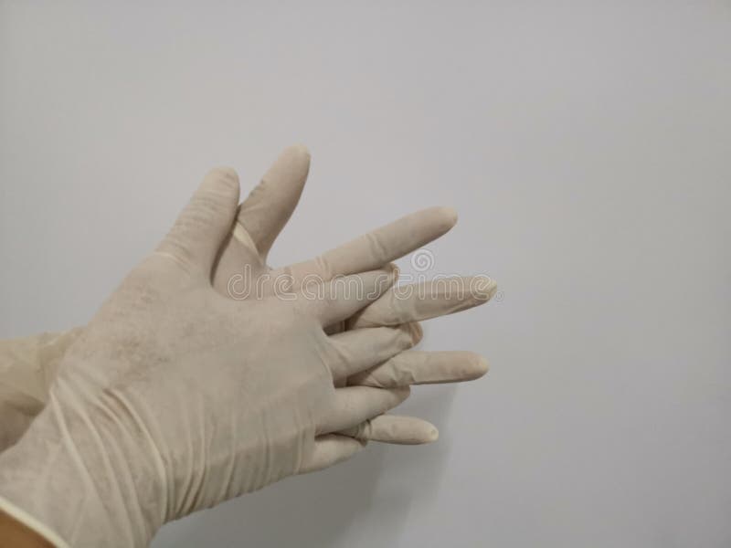 Händer, som bär gummihandskar, gör isolaten för handgester på vit bakgrund arkivfoto Händer, som bär gummihandskar, gör isolaten för handgester på vit bakgrund arkivfoto