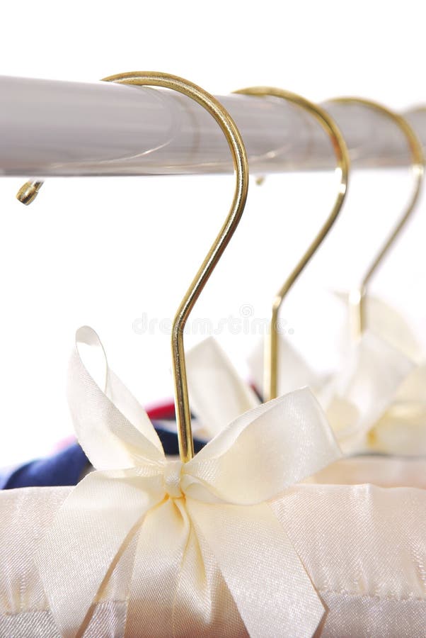 Luxury padded dress hangers on a clothes rack. Luxury padded dress hangers on a clothes rack