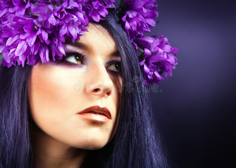 Härlig brunettflicka. Sunt långt hår. purpurfärgade blommor. arkivbild Härlig brunettflicka. Sunt långt hår. purpurfärgade blommor. arkivbild