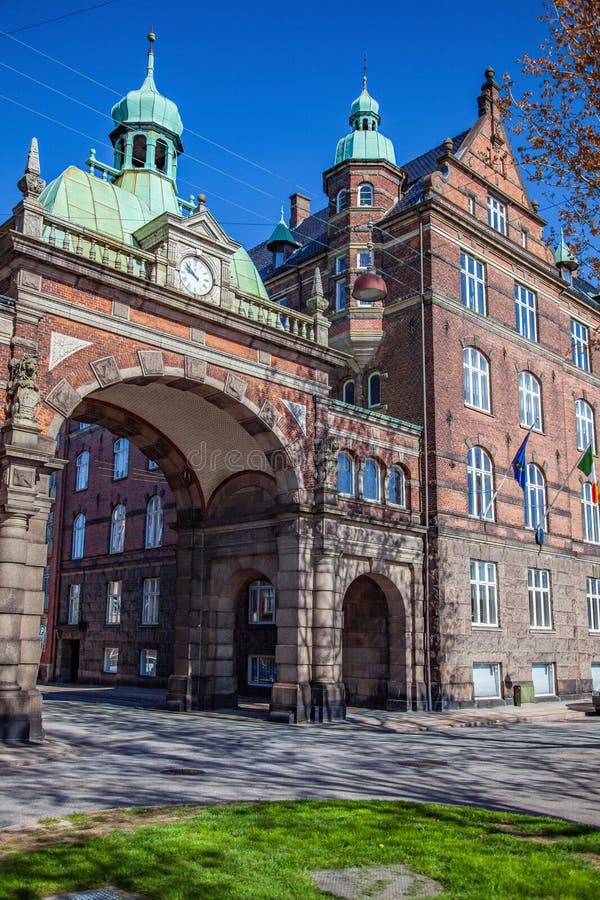 härlig historisk byggnad med valvgången, klockan och flaggor arkivfoto härlig historisk byggnad med valvgången, klockan och flaggor arkivfoto